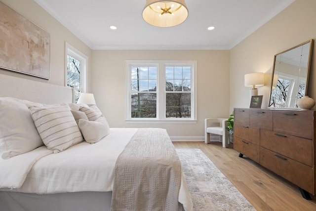 bedroom with crown molding and light hardwood / wood-style flooring