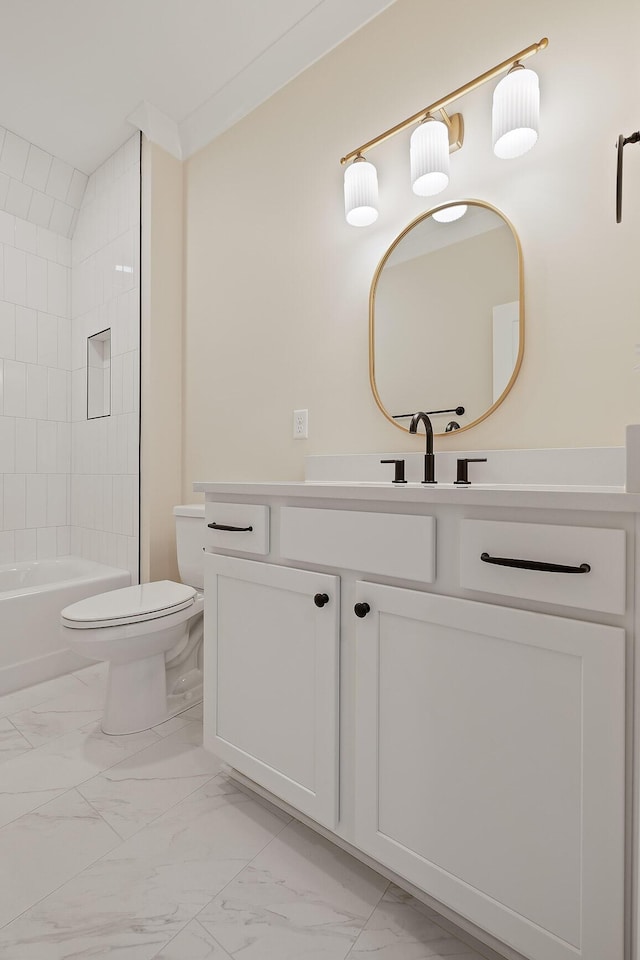 full bathroom with vanity, tiled shower / bath combo, and toilet