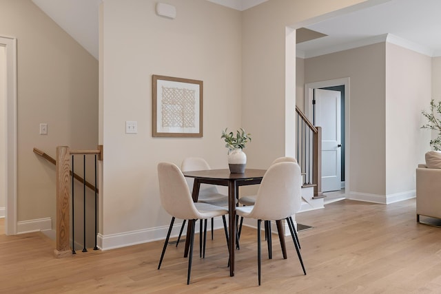 dining room featuring ornamental molding and light hardwood / wood-style floors