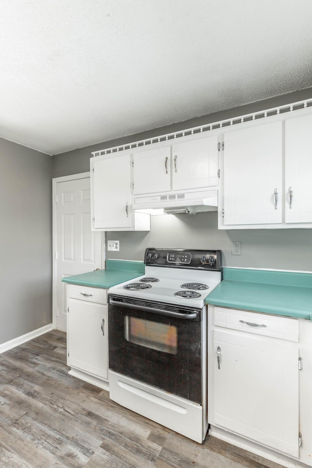 kitchen featuring wood-type flooring, white cabinets, a textured ceiling, and electric stove