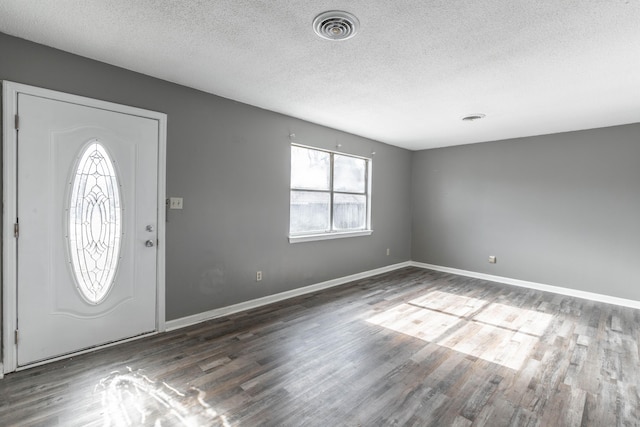 entryway featuring dark hardwood / wood-style flooring and a textured ceiling