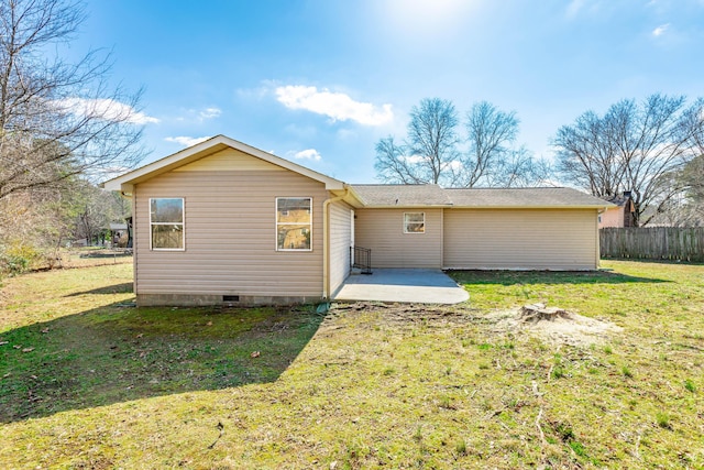 back of property with a lawn and a patio area