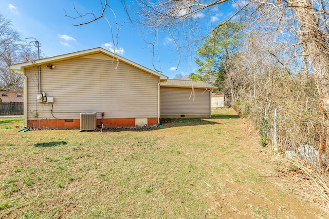 view of home's exterior with central air condition unit and a lawn