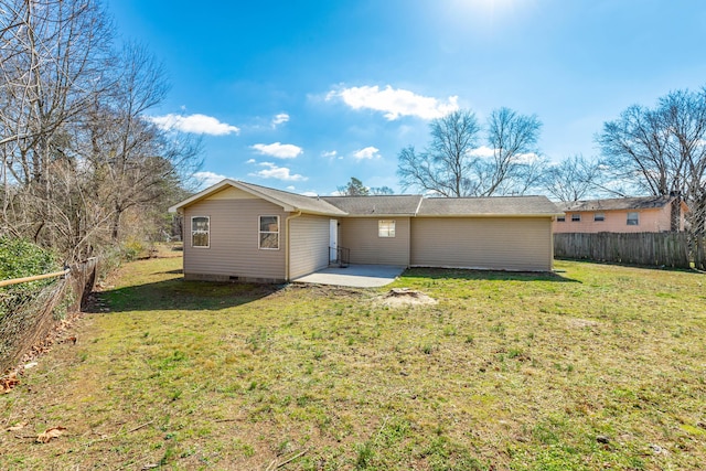 back of property with a patio and a yard