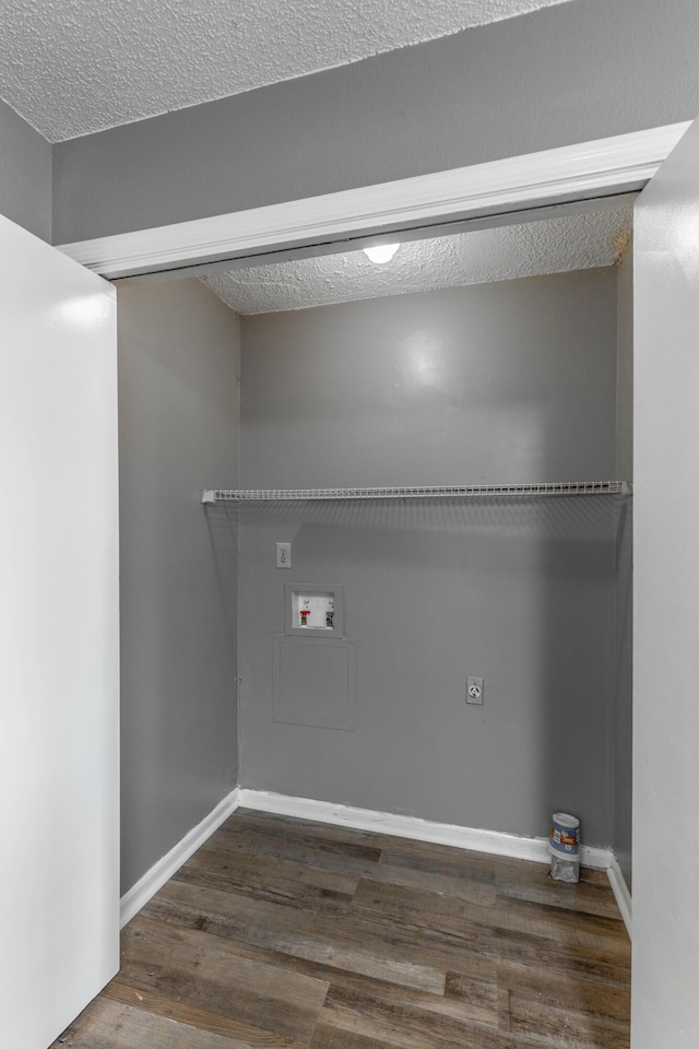 laundry area with washer hookup, dark hardwood / wood-style floors, and a textured ceiling