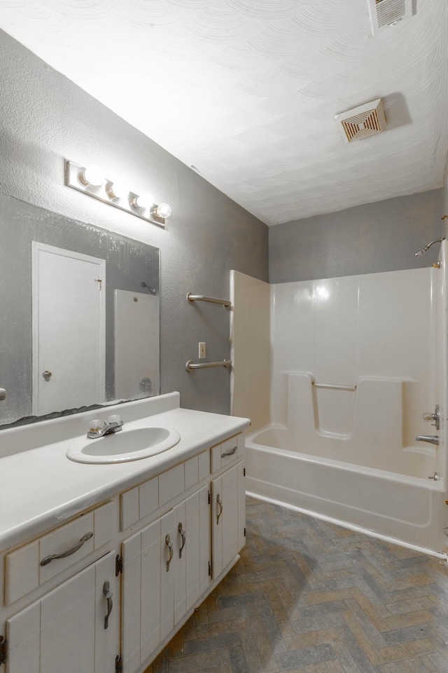 bathroom featuring vanity and washtub / shower combination