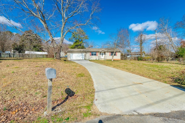 single story home with a garage and a front lawn