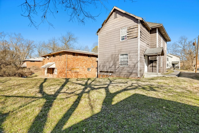 back of property featuring a lawn