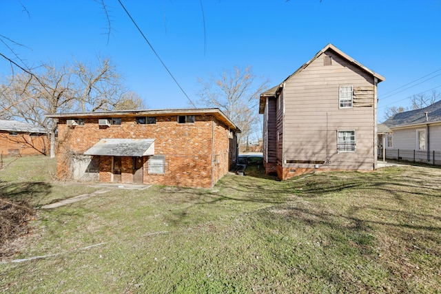 back of house with a lawn