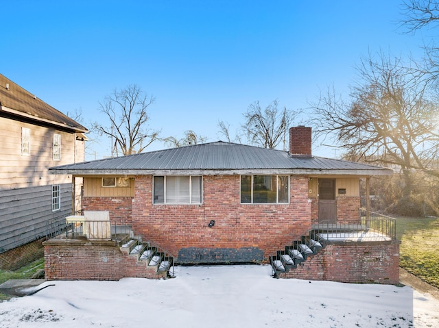 view of snow covered rear of property