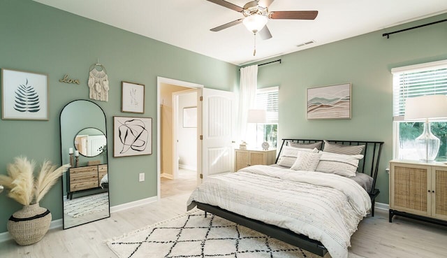 bedroom with ceiling fan and light hardwood / wood-style floors