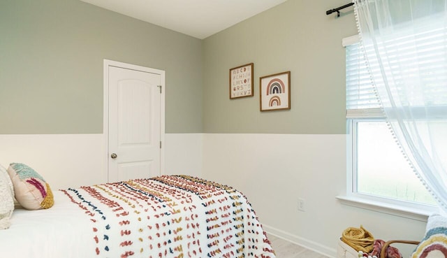 bedroom featuring multiple windows and light hardwood / wood-style floors