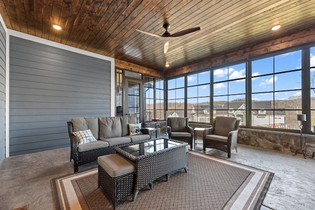 sunroom featuring ceiling fan and wood ceiling