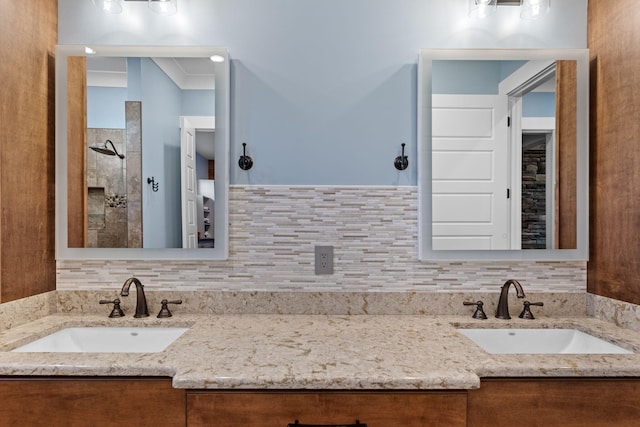 bathroom with vanity, decorative backsplash, crown molding, and walk in shower