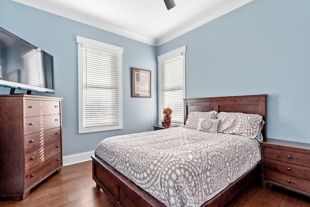 bedroom with crown molding, dark wood-type flooring, and ceiling fan