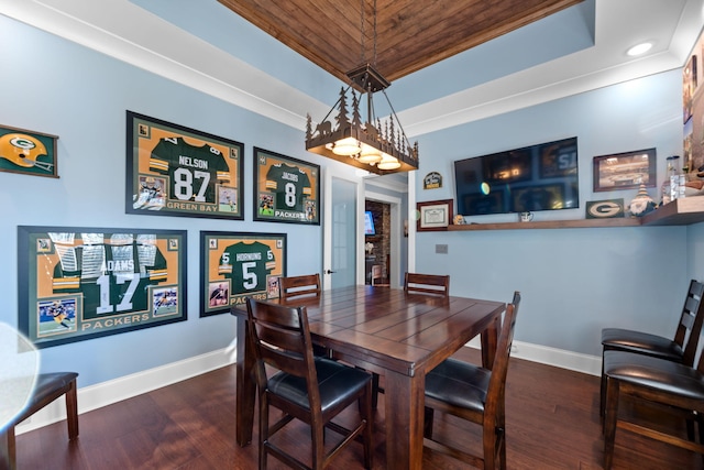 dining room featuring a raised ceiling and dark hardwood / wood-style flooring