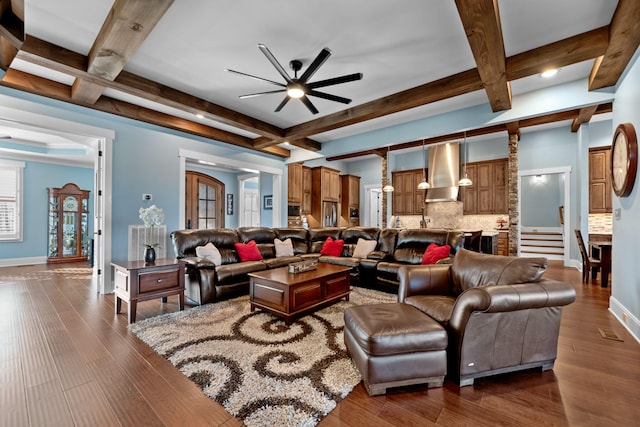 living room with beamed ceiling, coffered ceiling, dark hardwood / wood-style floors, and ceiling fan