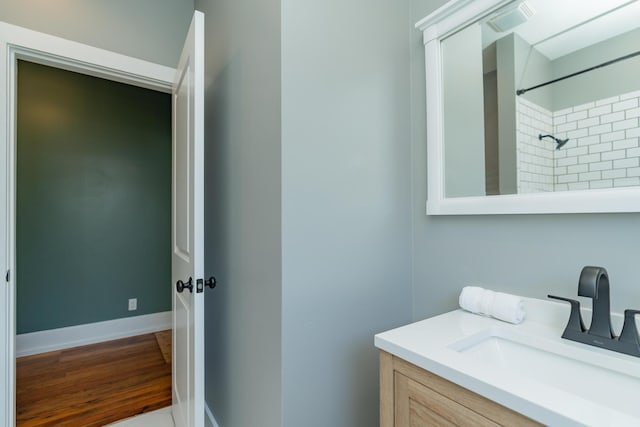 bathroom featuring vanity and a tile shower