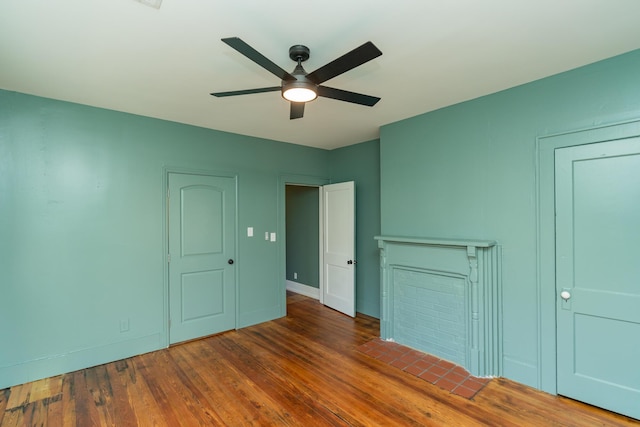 interior space featuring dark wood-type flooring and ceiling fan