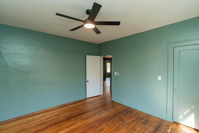 unfurnished bedroom with dark hardwood / wood-style flooring and ceiling fan