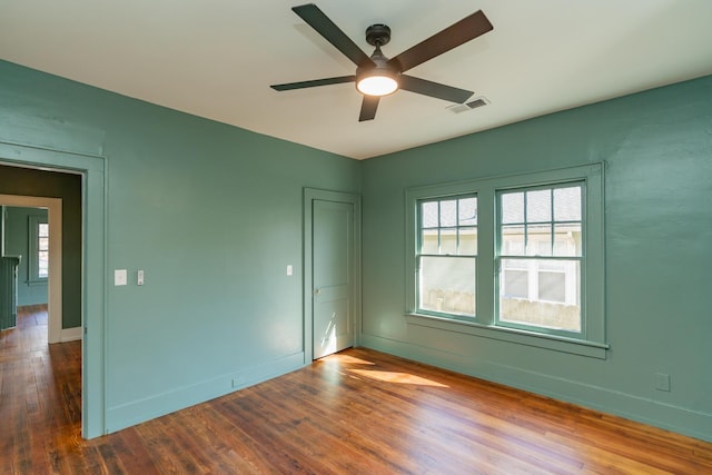 unfurnished room with hardwood / wood-style flooring, ceiling fan, and plenty of natural light