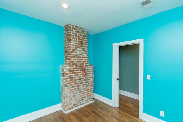 unfurnished room with wood-type flooring