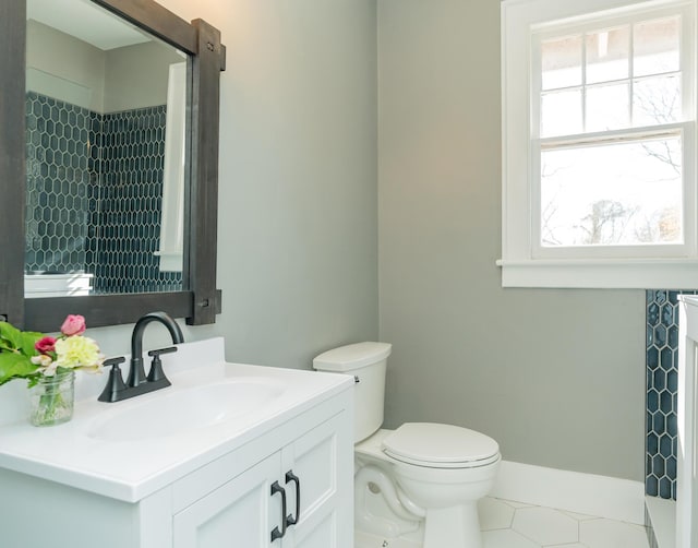 bathroom featuring tile patterned flooring, vanity, and toilet