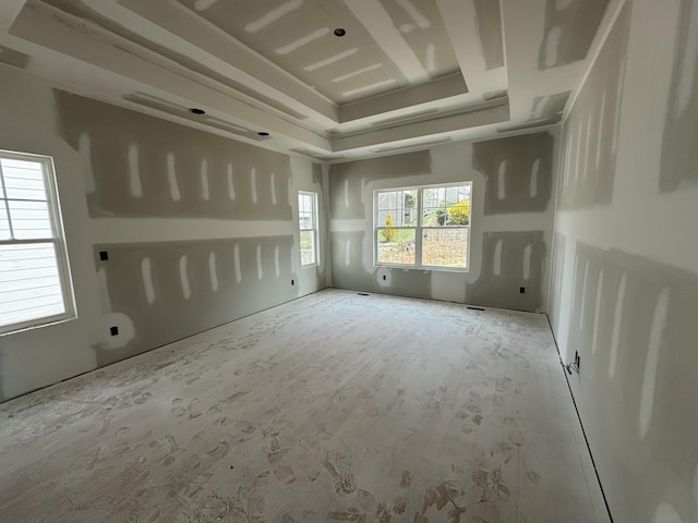 empty room featuring a raised ceiling