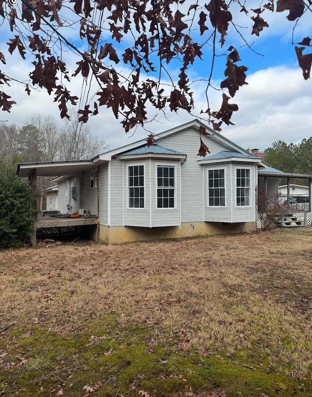 view of side of property with a lawn