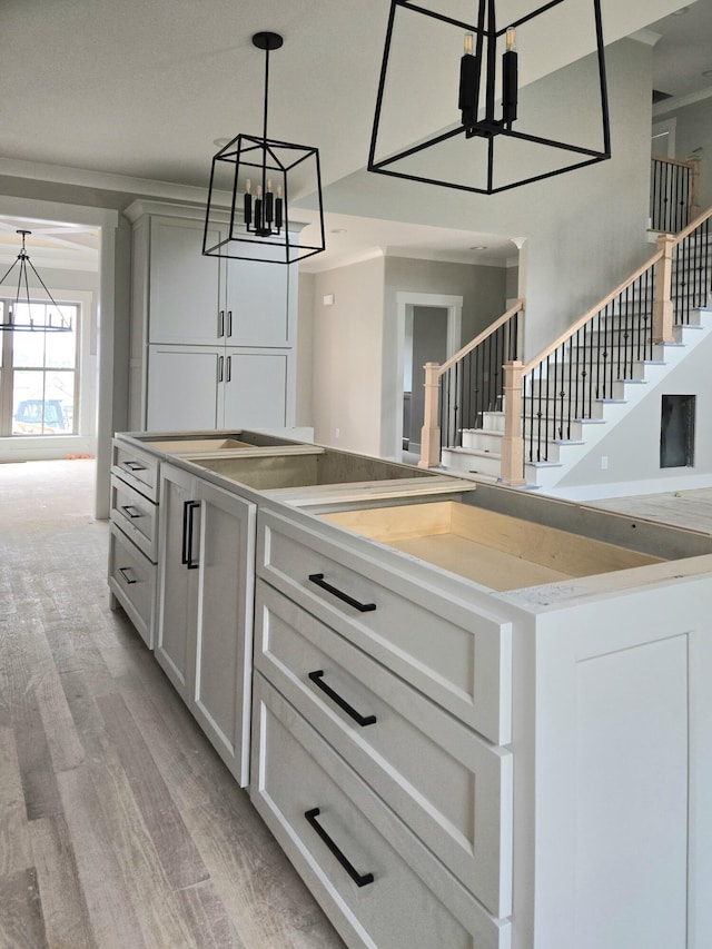 9892 Trestle Cir Unit 50, Ooltewah, TN 37363 - kitchen featuring a chandelier, light wood-type flooring, decorative light fixtures, light countertops, and white cabinetry