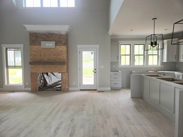 9892 Trestle Cir Unit 50, Ooltewah, TN 37363 - kitchen with light wood finished floors, a chandelier, healthy amount of natural light, and hanging light fixtures