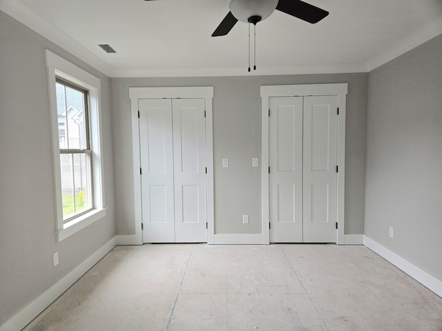 9892 Trestle Cir Unit 50, Ooltewah, TN 37363 - unfurnished bedroom featuring two closets, baseboards, multiple windows, and a ceiling fan