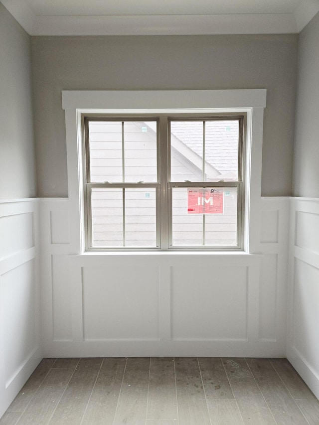 9892 Trestle Cir Unit 50, Ooltewah, TN 37363 - spare room with a wainscoted wall, a decorative wall, and wood finished floors