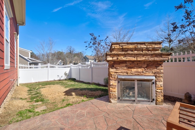 view of patio with an outdoor stone fireplace