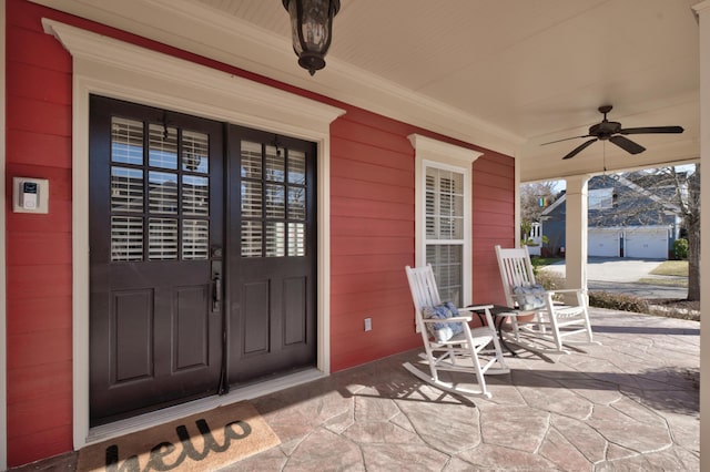 doorway to property featuring ceiling fan and a porch