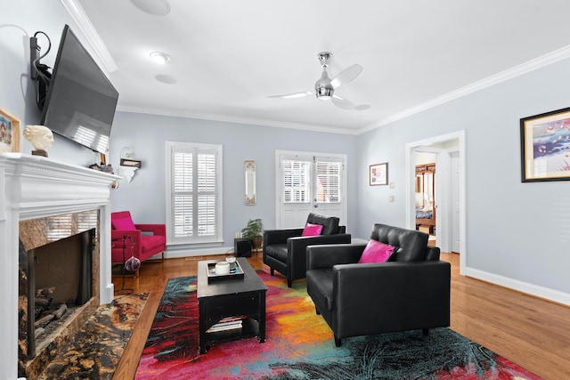 living room with hardwood / wood-style flooring, ornamental molding, and a premium fireplace