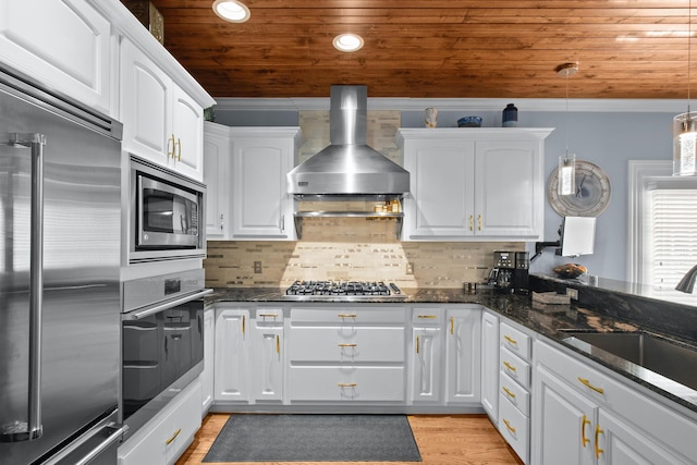 kitchen featuring pendant lighting, white cabinetry, and built in appliances