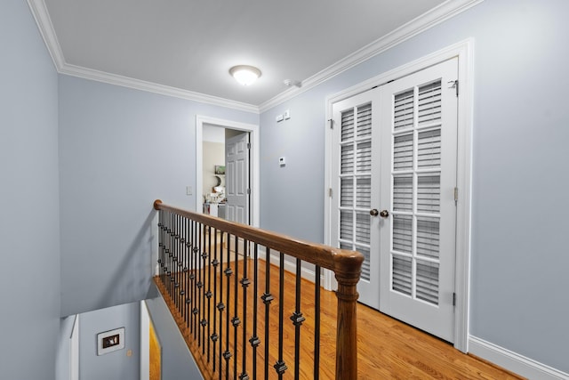 corridor featuring crown molding, wood-type flooring, and french doors