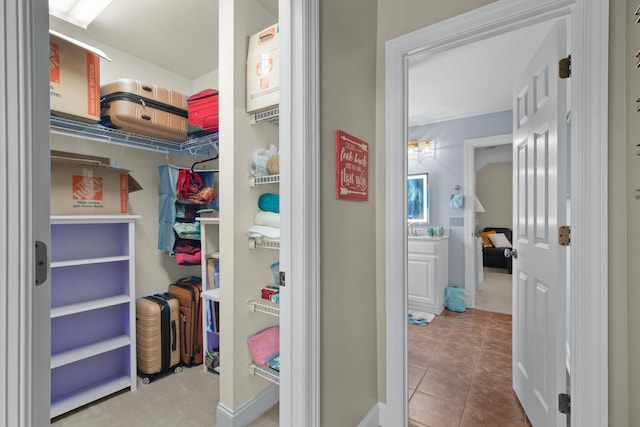 walk in closet with tile patterned flooring