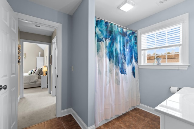 bathroom featuring vanity, curtained shower, and tile patterned floors