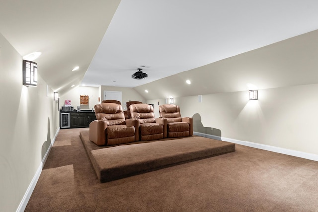 carpeted cinema room featuring vaulted ceiling