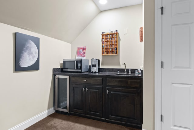 bar with wine cooler, sink, dark carpet, and vaulted ceiling