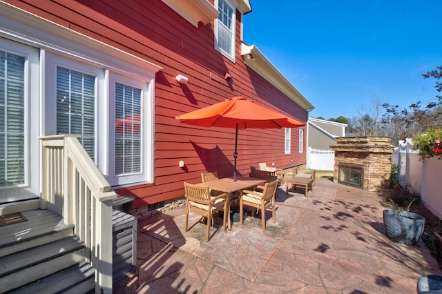 view of patio / terrace with an outdoor stone fireplace