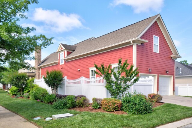 8625 Homecoming Dr, Chattanooga, TN 37421 - view of property exterior featuring driveway, an attached garage, a chimney, and a shingled roof