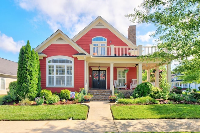 8625 Homecoming Dr, Chattanooga, TN 37421 - view of front of home featuring covered porch, a chimney, a front yard, and a balcony