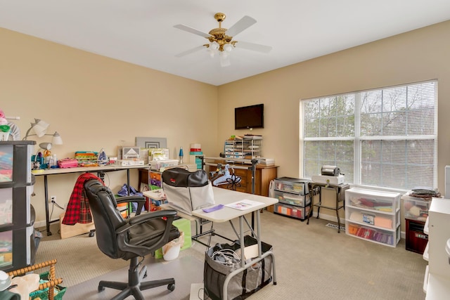 carpeted office space with ceiling fan