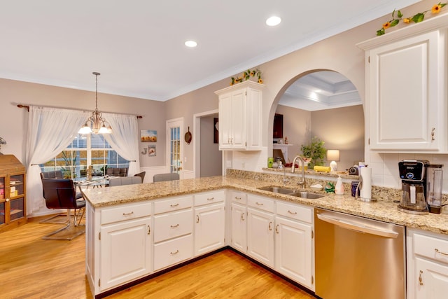 kitchen featuring sink, white cabinets, stainless steel dishwasher, kitchen peninsula, and light wood-type flooring