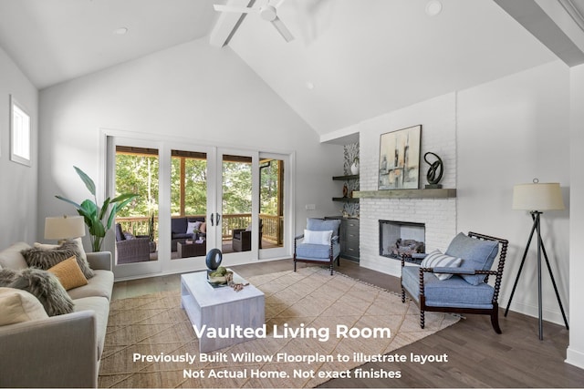 living room with hardwood / wood-style flooring, a wealth of natural light, a fireplace, and high vaulted ceiling