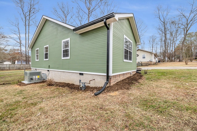 view of property exterior featuring central AC unit and a lawn