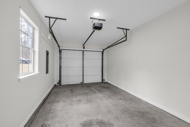 garage with a garage door opener and electric panel